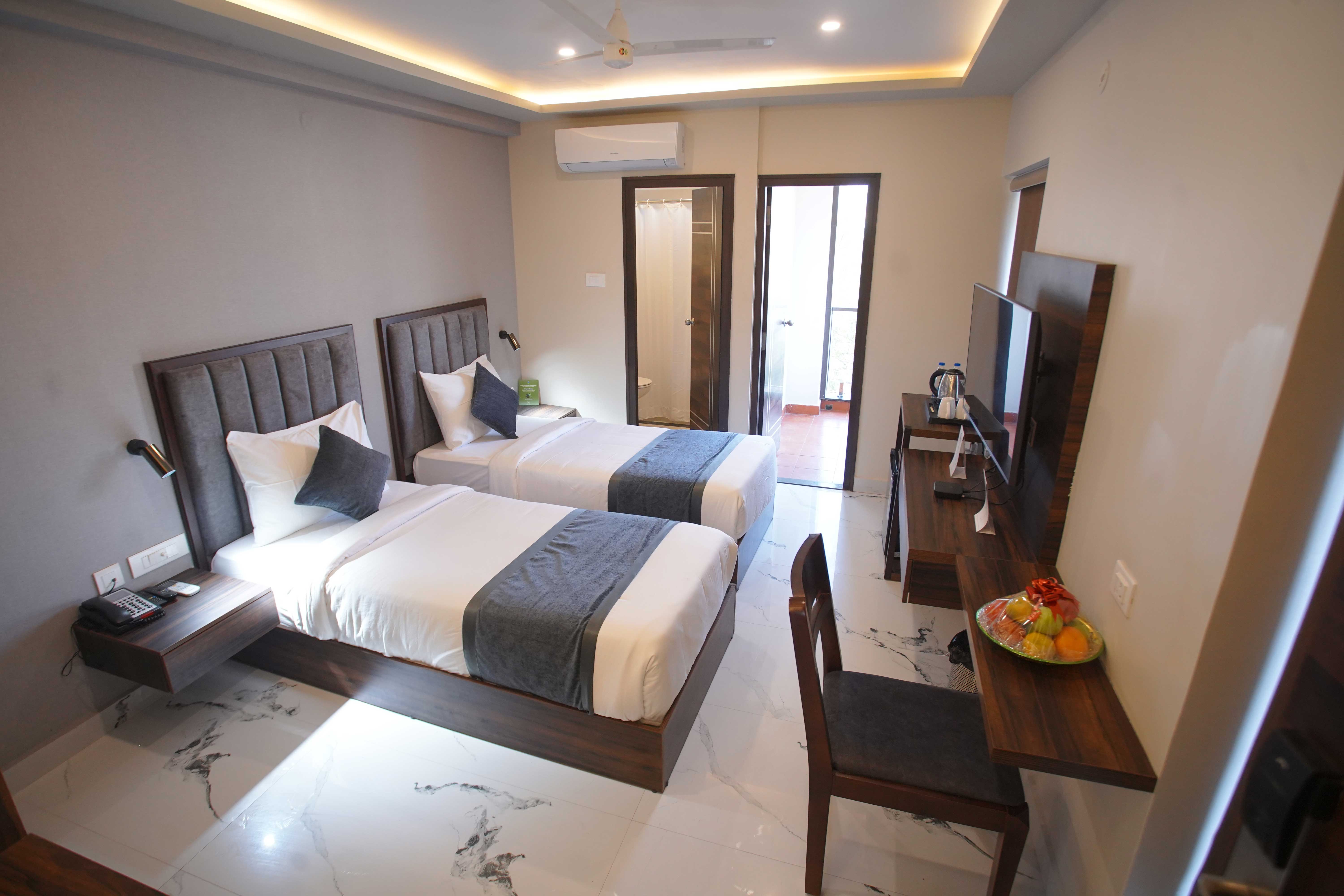 Studio Room at BLOFT HOTEL, Vellore with twin beds, attached bathroom, balcony access, and modern amenities