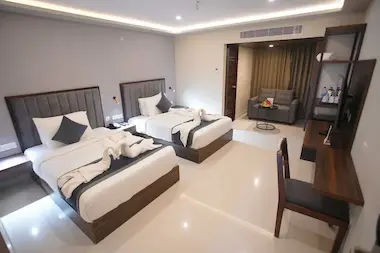 Modern Club Room in BLOFT HOTEL, Vellore with twin beds, towel art, smart TV, and comfortable seating area