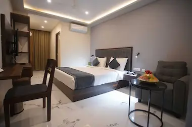 Elegant executive accommodation at Bloft Hotel Vellore with premium bedding, ergonomic workspace, and luxurious marble flooring.