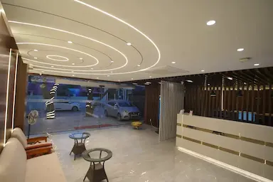 Modern hotel lobby at Bloft Hotel Vellore with stylish ceiling lights and reception area.