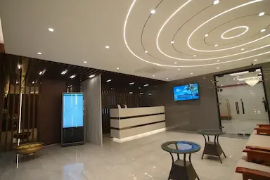 Luxury hotel reception with modern interiors and digital display at Bloft Hotel Vellore.