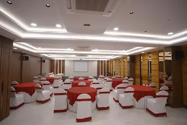Spacious conference hall with banquet seating at Bloft Hotel Vellore.