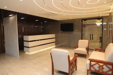 Reception and seating area with artistic ceiling design at Bloft Hotel Vellore.