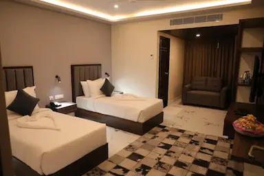 Twin executive beds with study table and modern lighting at Bloft Hotel Vellore.