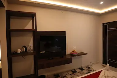 Hotel room with entertainment unit and workspace at Bloft Hotel Vellore.