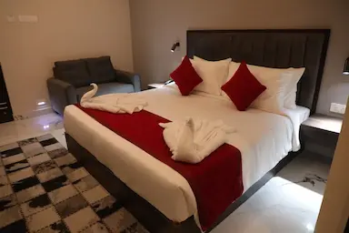 Premium suite room at Bloft Hotel Vellore with red and white bedding and luxury decor.