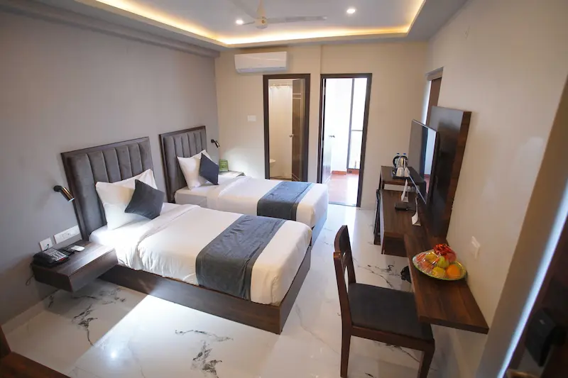 Studio Room at BLOFT HOTEL, Vellore with twin beds, attached bathroom, balcony access, and modern amenities