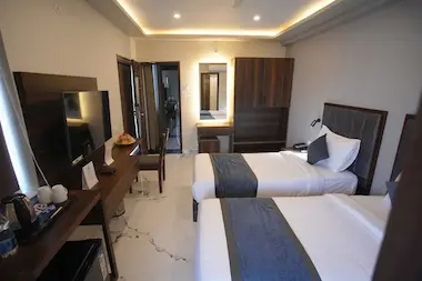 Cozy Studio Room in BLOFT HOTEL, Vellore featuring twin beds, smart TV, dressing area, and wardrobe