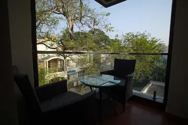 Private balcony at Bloft Hotel in Vellore featuring cozy outdoor seating with city and greenery view